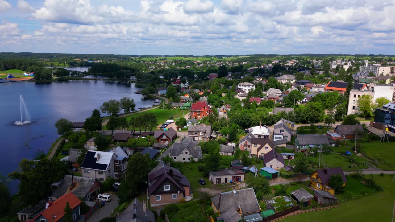 High-angle aerial shot showing Zarasai town nestled around a peaceful lake with green landscape. Drone Shot at Zarasai, Lithuania