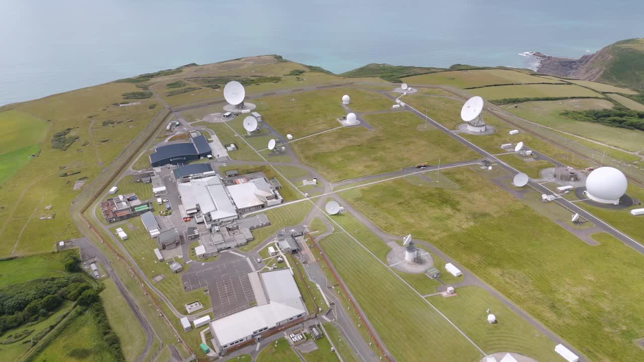Aerial view of GCHQ Bude, showcasing satellite dishes and facility layout near coastline, Devon, UK, July 2024