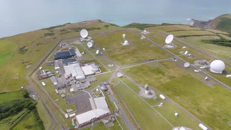 aerial view of gchq bude, showcasing satellite dishes and facility layout near coastline, devon, uk, july 2024