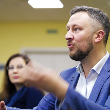 executive leader explaining the main rules of successful business gesticulating a lot. businessman shares his experience with the audience in a conference hall.
