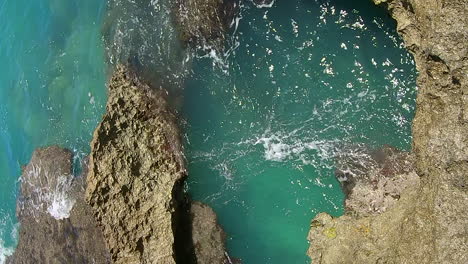 natural blowhole and crystal water shot from above, in isle of pines, new caledonia