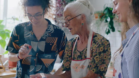 grandmother holding cherry tomatoes and teaching grandchildren how to cook