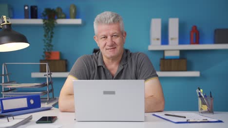 home office worker man talking motivationally to camera.