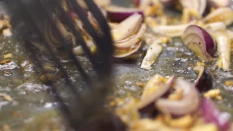 frying onions and garlic in a pan