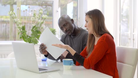 Worried-Couple-Looking-Through-Bills