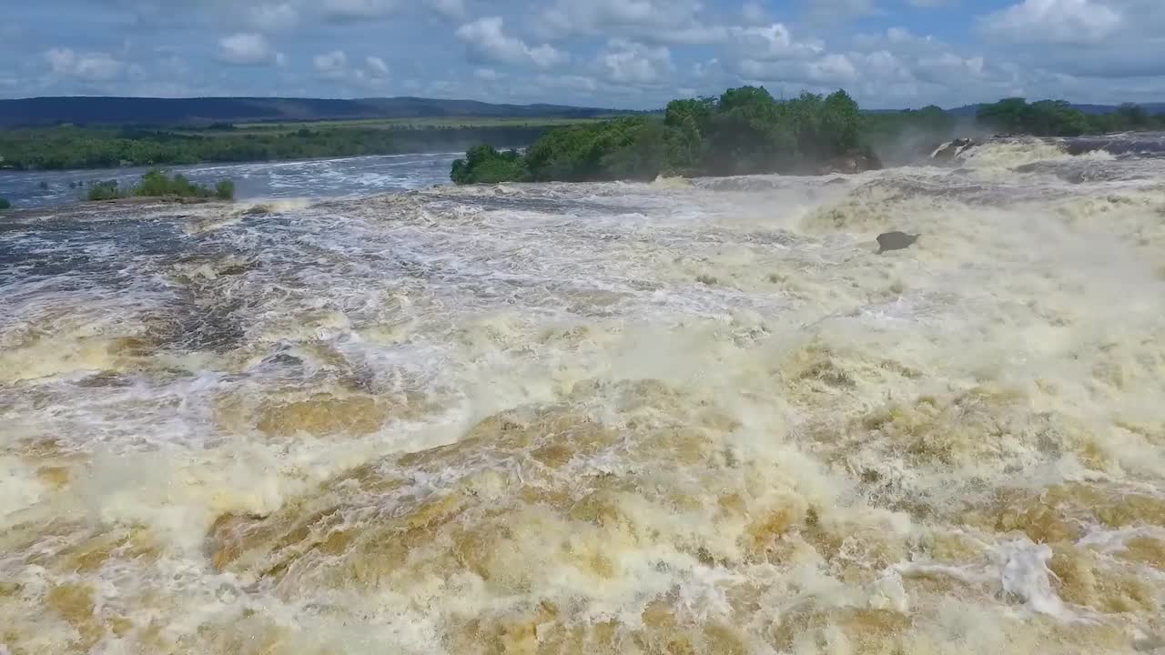 Slow motion shot of the stream flow of the Carro River about to fall in the Hacha Waterfall, Canaima, Venezuela