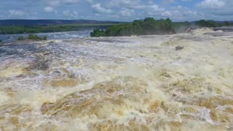 slow motion shot of the stream flow of the carro river about to fall in the hacha waterfall, canaima, venezuela