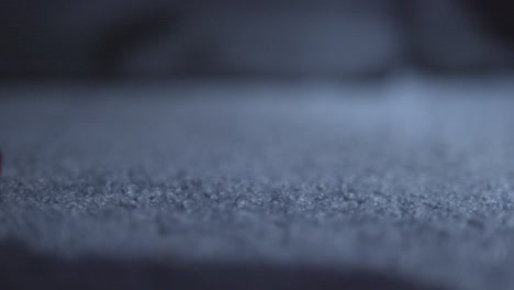 eyeball, covered in blood, with the pupil looking around, rolls across the floor, in a horror film style vfx low angle, close up shot