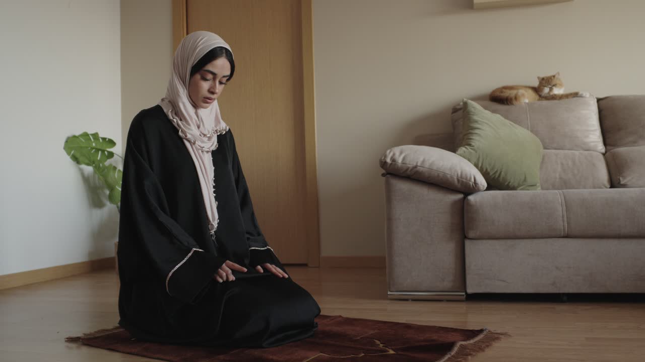 A Muslim woman praying at home