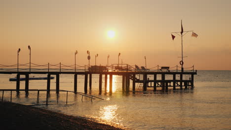 Dawn-Over-The-Sea-Silhouette-Of-A-Pier-That-Protrudes-Into-The-Water---A-Scenic-Landscape-Of-Summer-