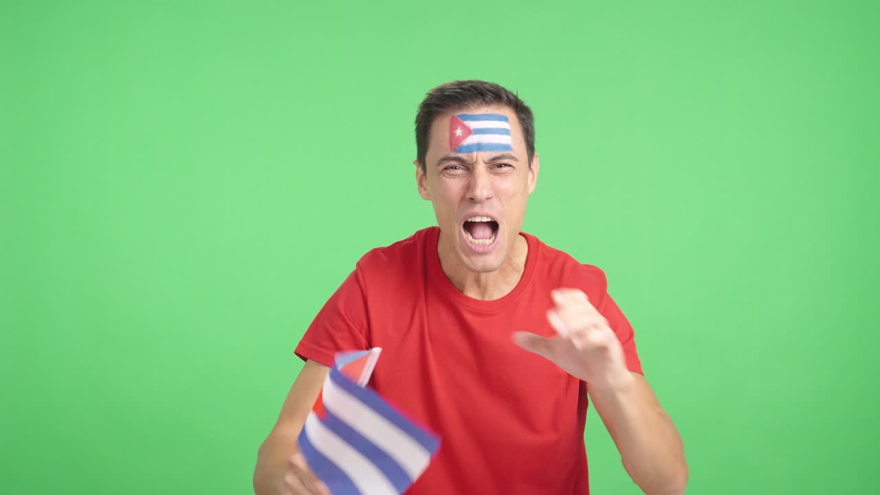Man cheering for Cuba screaming and waving a national flag