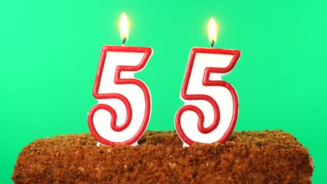 cake with the number 55 lighted candle. chroma key. green screen. isolated