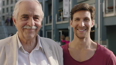 family reunion portrait of elderly father and adult son smiling happy together