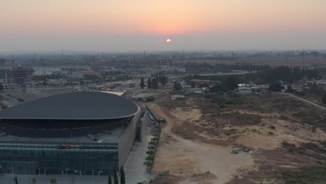 aerial view of modern building and cityscape during sunrise/sunset