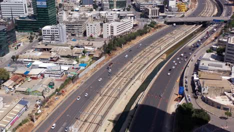 aerial view of city streets and highway with railroad tracks