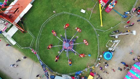 spiral down at amusement park in west virginia, usa with funfair rides and people