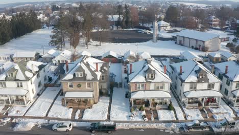 establishing shot of large houses in united states, homes line small town street in america, usa housing residential community neighborhood during winter