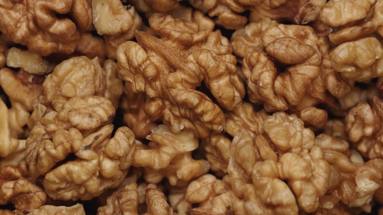 Smooth Camera Movement Over a Handful Walnuts.