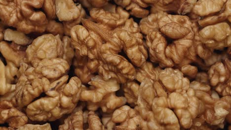 smooth camera movement over a handful walnuts.