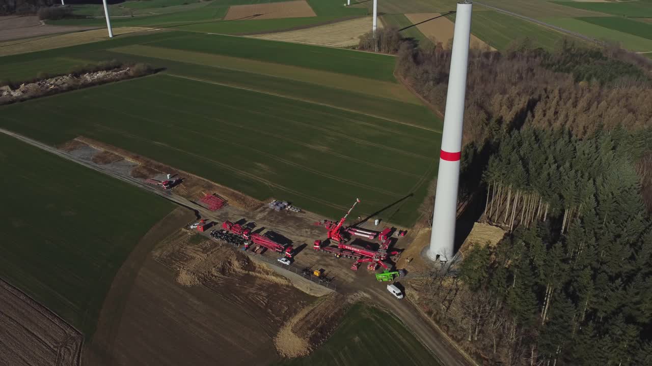 Construction Site Of Wind Turbine In Green Fields - aerial shot