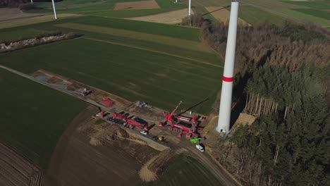 Construction-Site-Of-Wind-Turbine-In-Green-Fields---aerial-shot