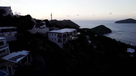 Aerial-pull-out-wide-view-of-beautiful-home-on-the-mountain-dusk-sunset-gradient-sky-with-tranquil-scene-and-background-relaxation