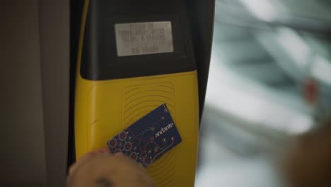 hand tapping andante public transportation card in porto, portugal - close up slowmo