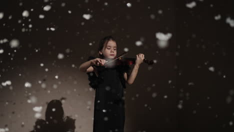 young girl playing violin in a winter scene