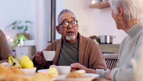 Senior-couple,-conversation-and-happy-in-kitchen