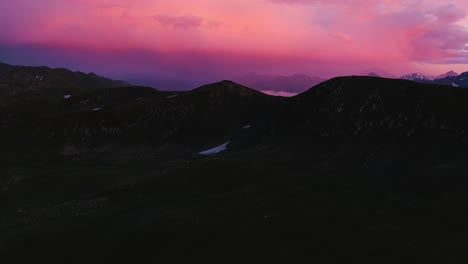 aerial spectacle of passing peaks and revealing pink sky (high-res footage)