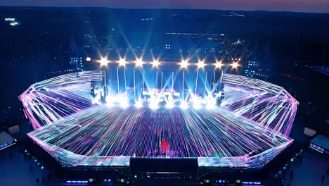 stadium concert venue glows with a spectacular light show at dusk, creating an electrifying atmosphere for the audience