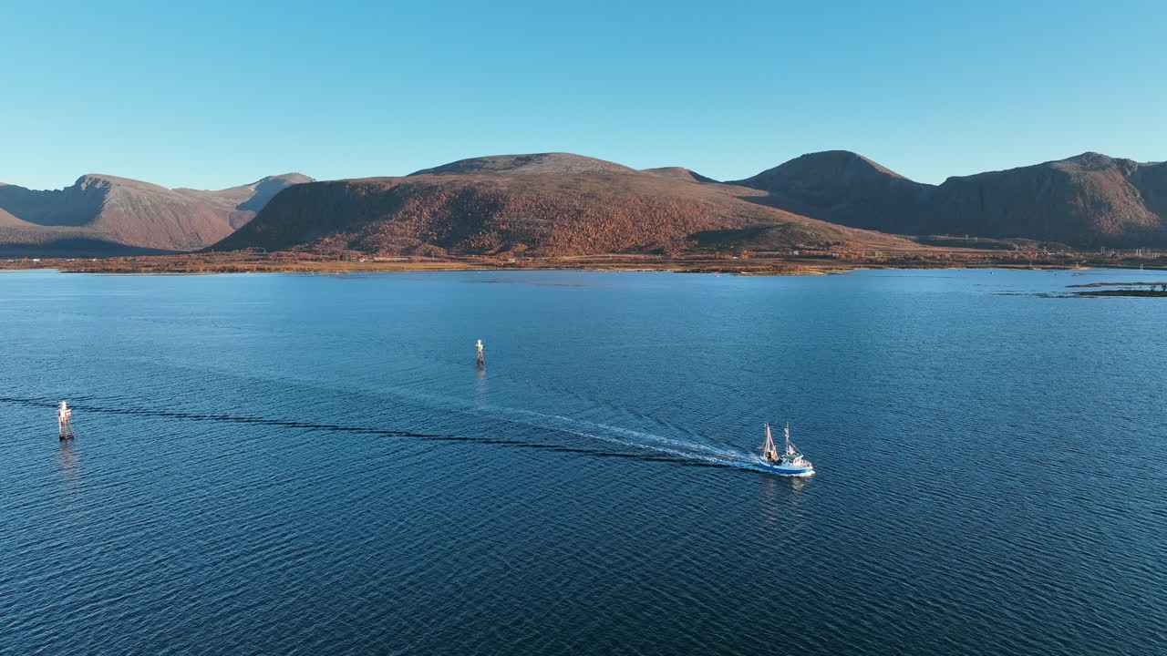 Captured along the Norwegian coast, this cinematic story features a fishing boat approaching the harbor.
