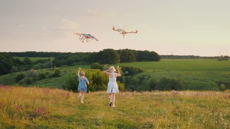 Woman-With-A-Girl-Running-With-An-Air-Kite-Happy-Mom-With-Daughter-Concept-Back-View-4K-Slow-Motion