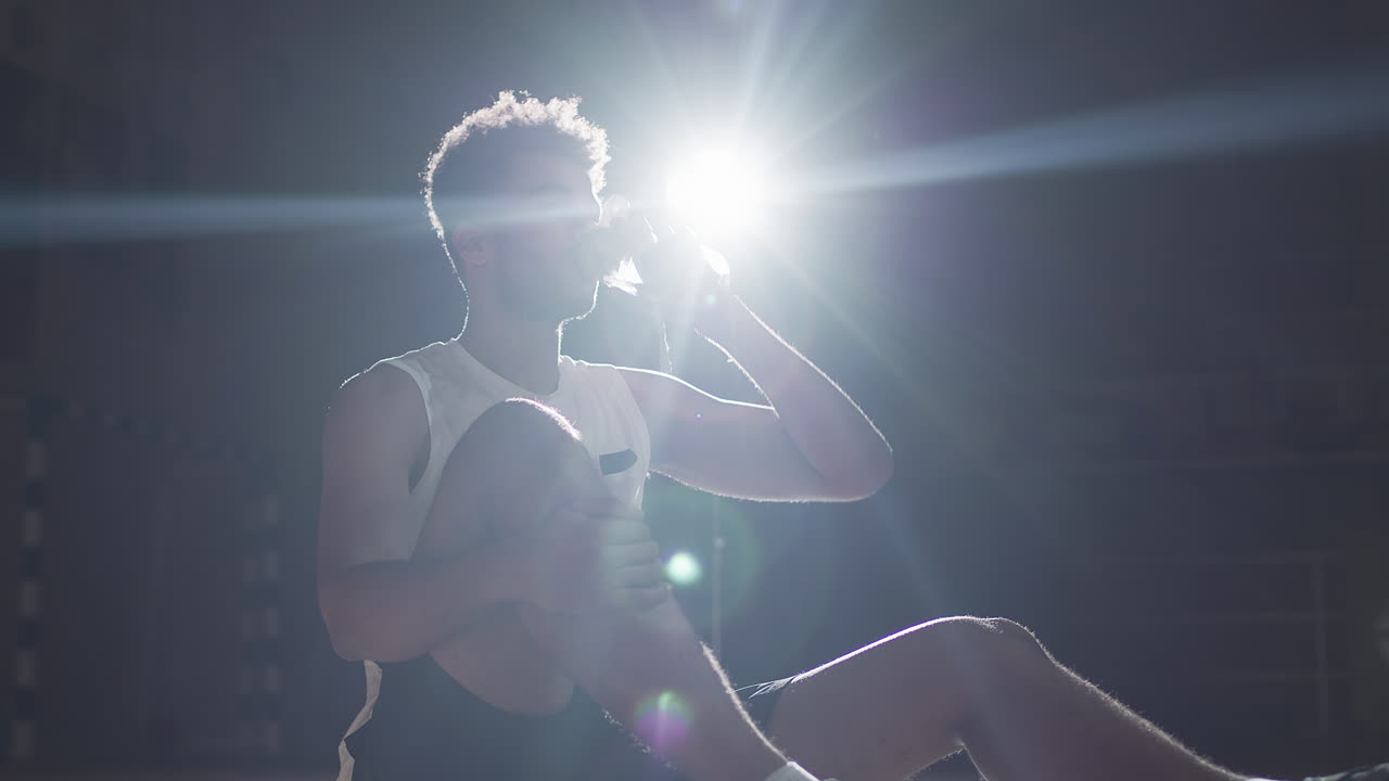 Slowmo of Basketball Player Resting and Drinking Water