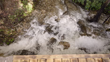 small waterfall through forest in eryuan county, yunnan, china