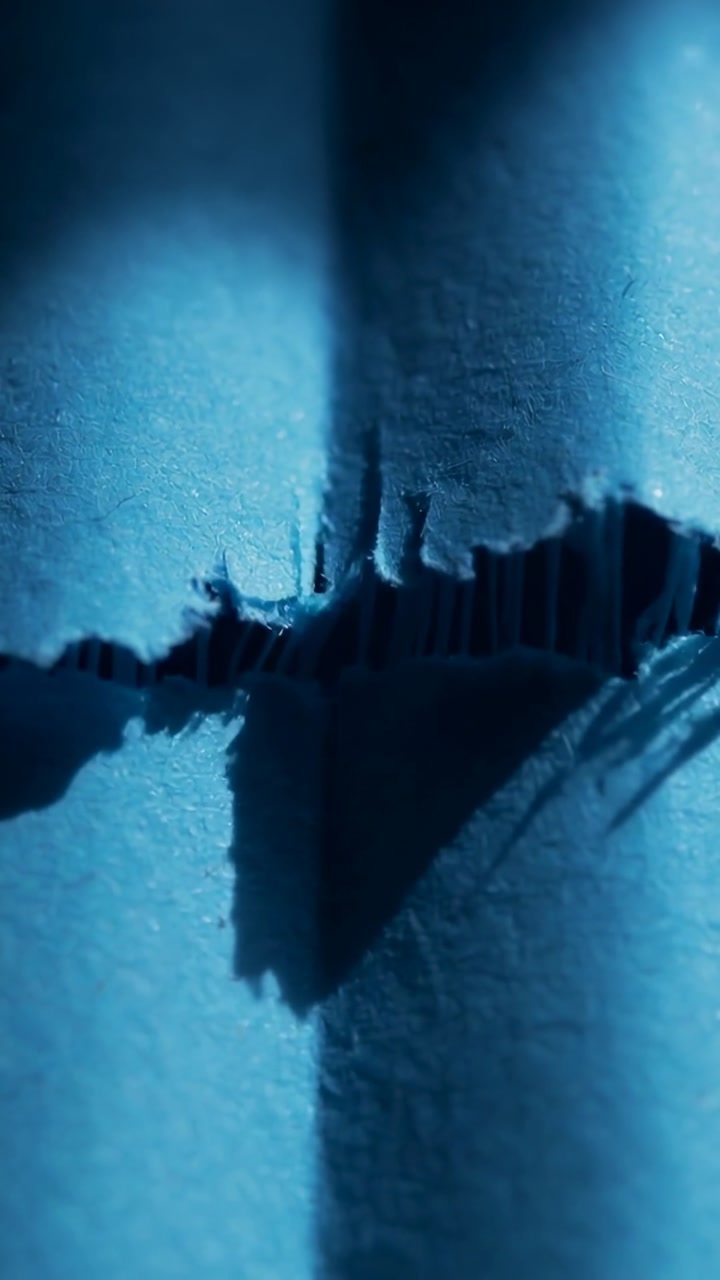 Close-Up Macro Shot of Blue Paper Tearing Apart