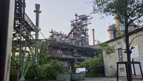 large-old-industrial-site-with-metal-structure-old-pipes-and-chimneys-Landscape-Park,-Duisburg,-Germany