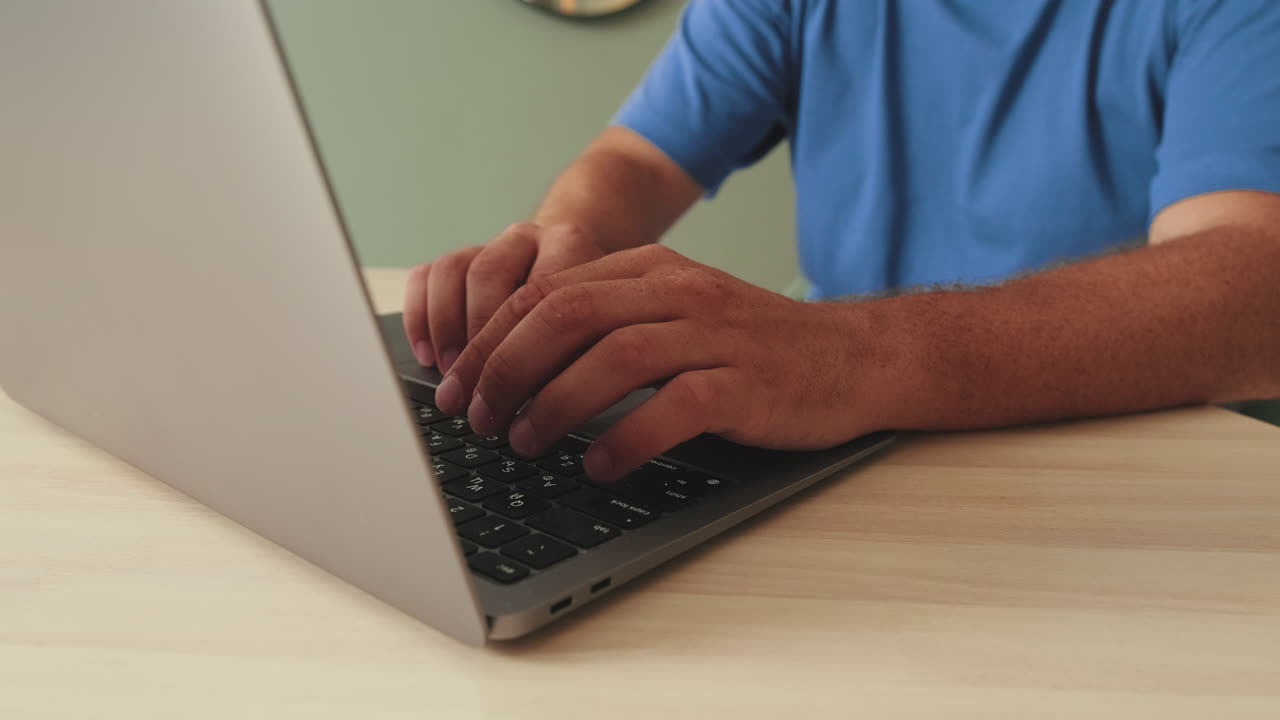 Close Up of Hands Typing on Laptop Keyboard