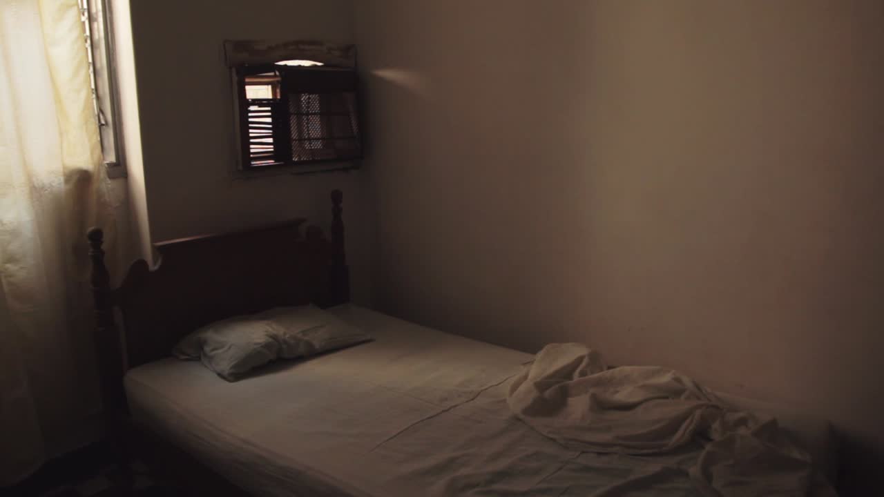 Close shot of bed at cheap hotel in the border city of Maicao, Colombia