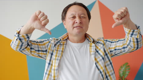 disapproving man with thumbs down