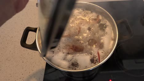 boiling soup with meat and vegetables.