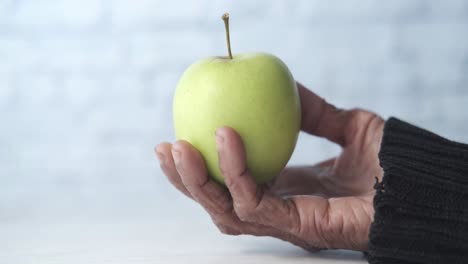 green apple in aged hand