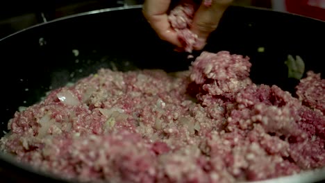 slow motion - mince meat being fried in a pan