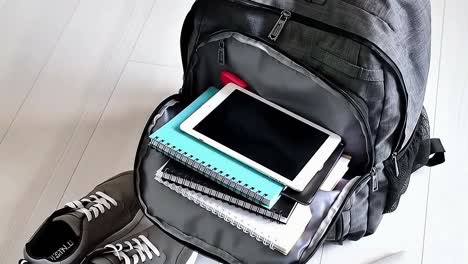 open school backpack with tablet and notebooks packed for college or university