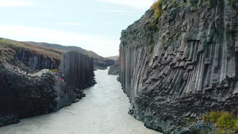 Antena-Escénica-A-Lo-Largo-De-La-Garganta-Con-Río-Glacial---Formaciones-Rocosas-De-Basalto,-Studlagil