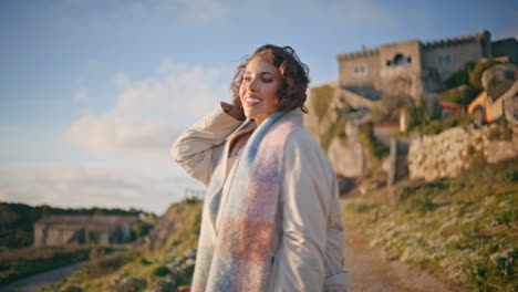 cheerful traveler posing medieval castle view looking camera with smile closeup.