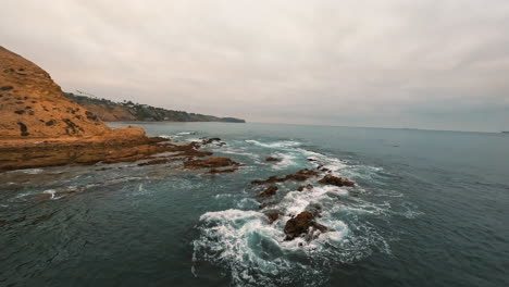 circular footage of coastal rocks washed by mild waves and calm basins at rock outcrop