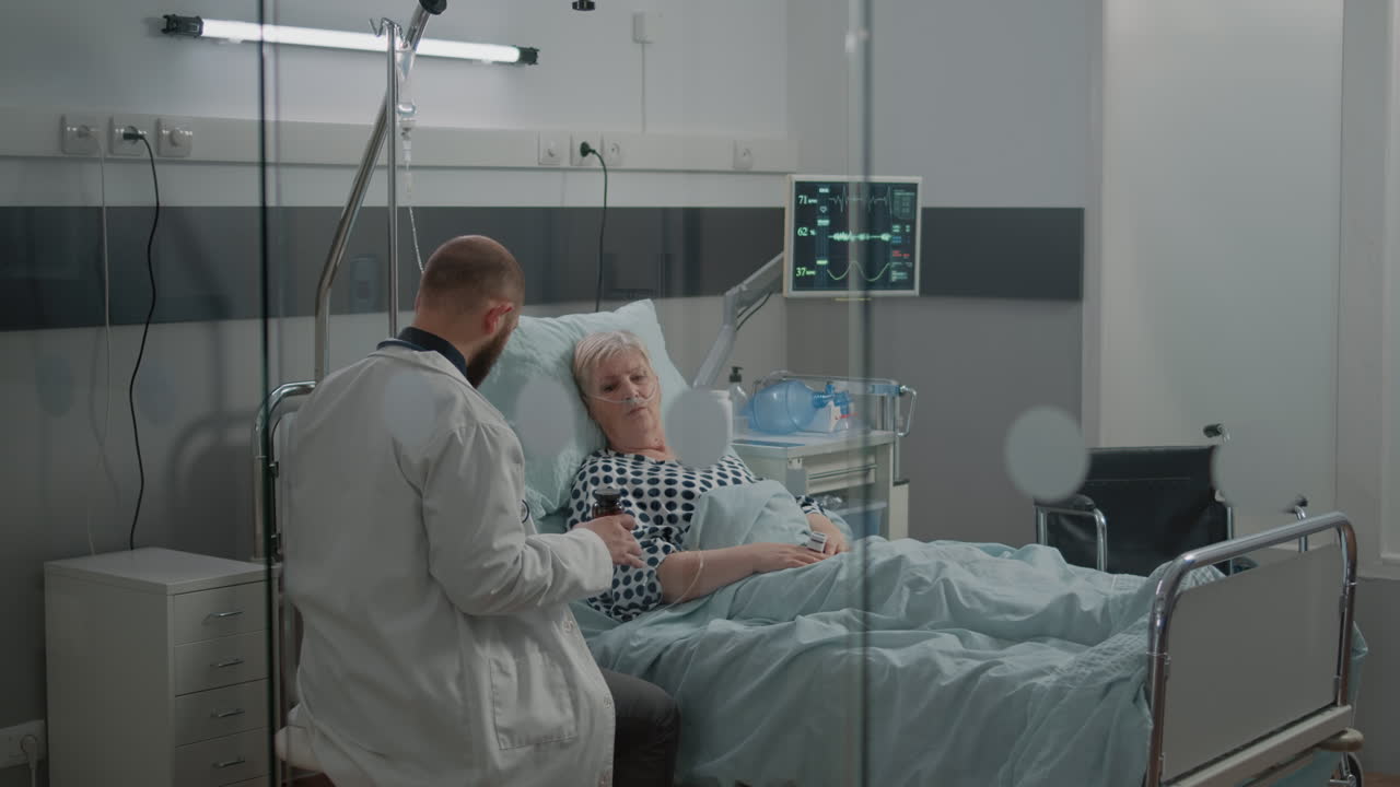 Doctor giving bottle of pills for old patient with illness