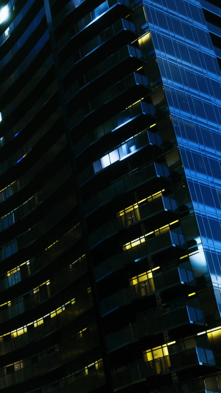 Night view of a modern building with bright windows in a city