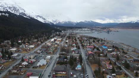 aerial shot drone flying over the small town of seward alaska during the winter